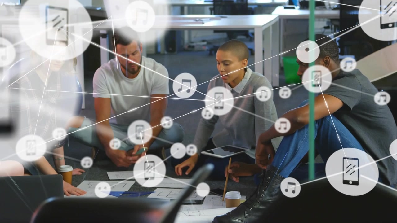 Animation of network of digital icons over diverse colleagues discussing together at office