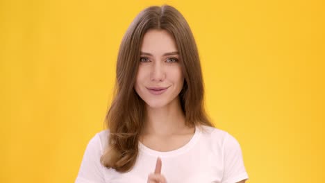 woman making a shhh gesture