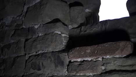 Window-of-old-stone-building-close-up-tilting-shot