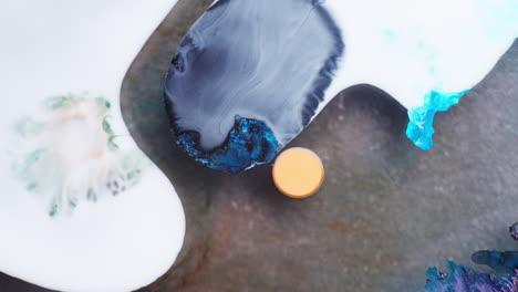 white ink getting in contact with blue spherical ink in between in a liquid media