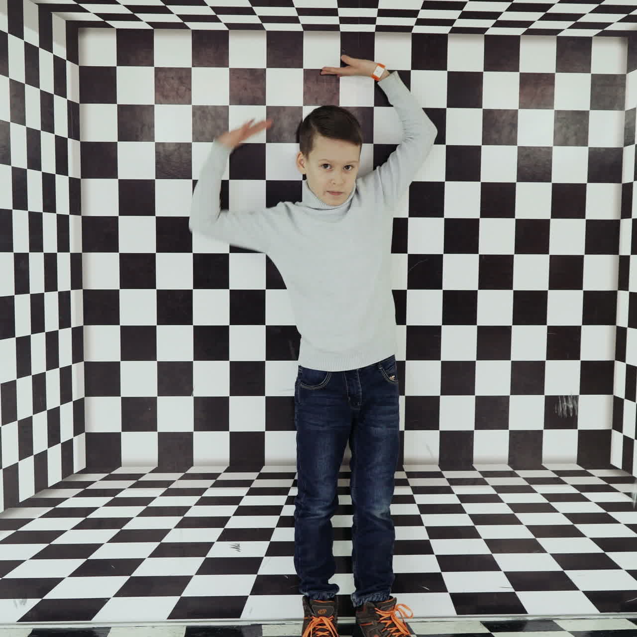 Boy watching a whirlwind of optical illusion in the science center Square video