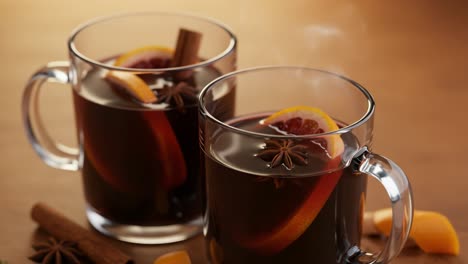 steaming mulled wine with orange slices and spices