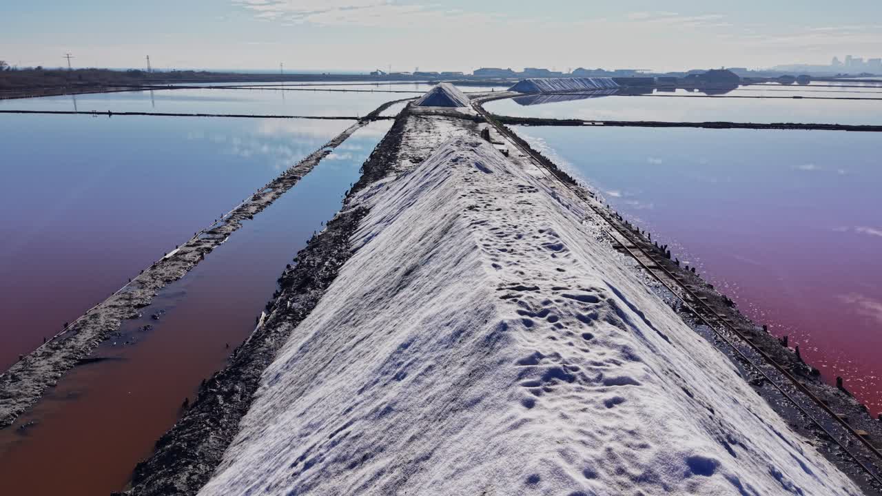 Salt production process at a salt farm in sunny weather