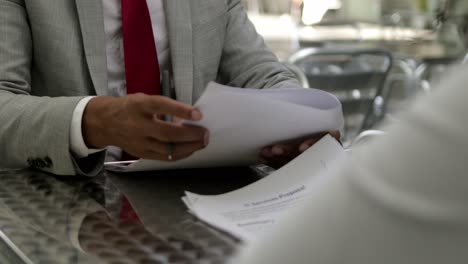 front view of male hands signing documents