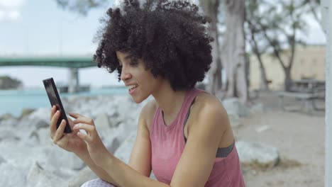 young girl using phone for selfie on riverside