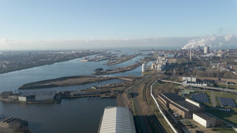 aerial of large industrial terrain with ship lock in river