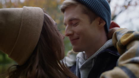 close up view of happy young couple hugging with tenderness outdoors.