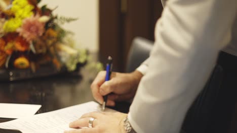 Groom-signs-his-marriage-license