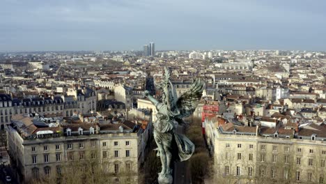 Angel-of-liberty-Girondins-monument-Bordeaux,-France-with-city-panoramic,-Aerial-dolly-out-reveal-shot