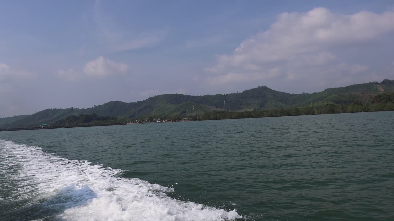 울창 한 언덕 이 있는 조용 한 호수 에 있는 보트 와이크