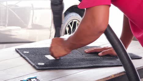 cleaning a car mat