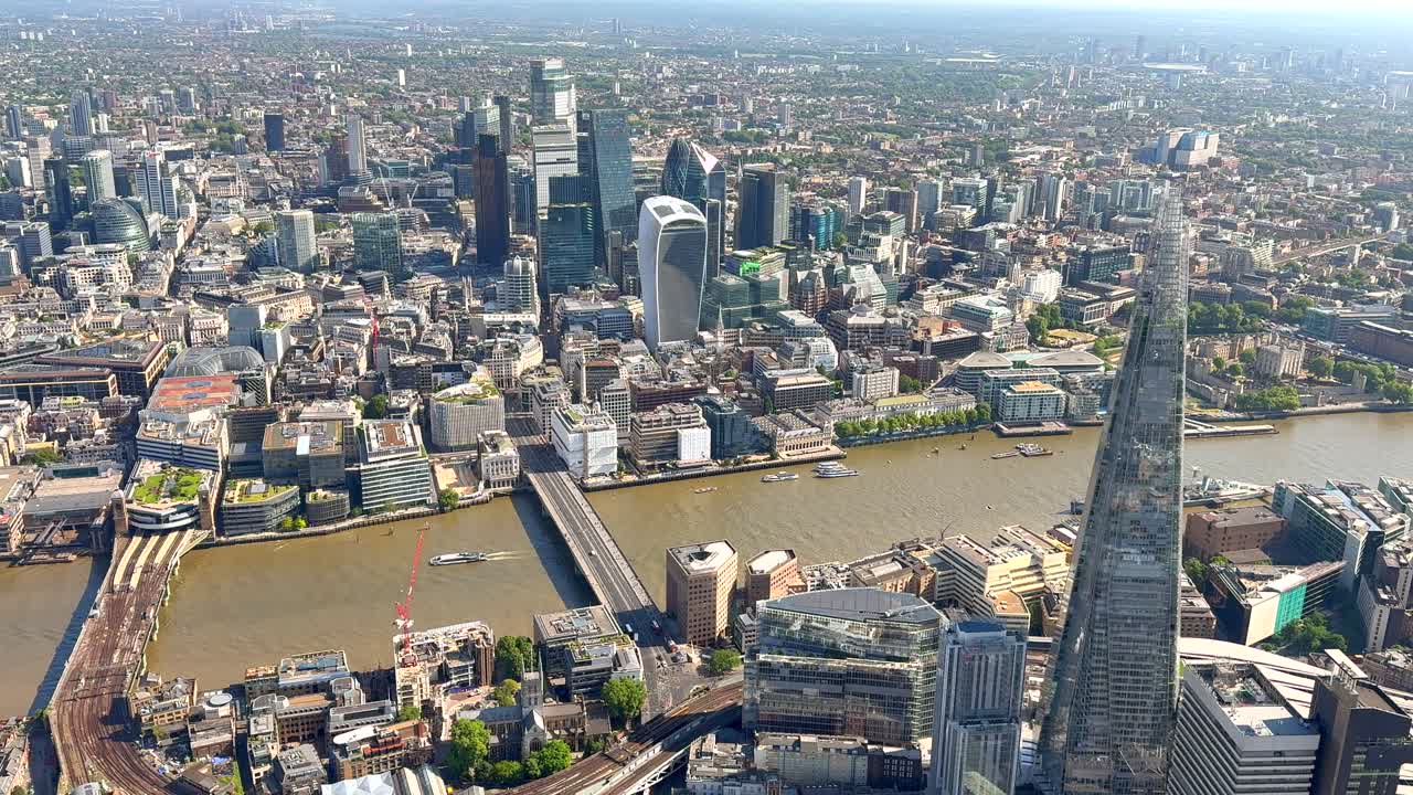 Aerial view of London Bridge and the Shard with the City of London behind in bright sunlight. London, UK.