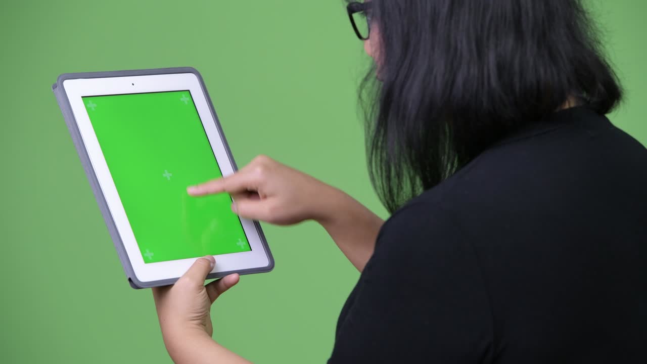 Beautiful Asian businesswoman using digital tablet