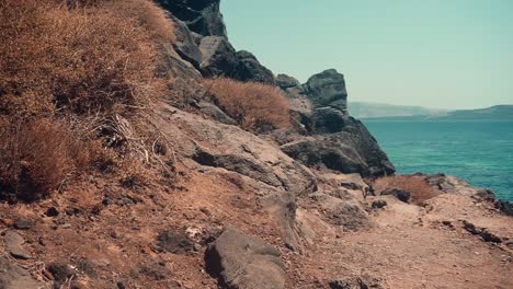 slow walking up a path over a cliff in a beautiful greek island during summer