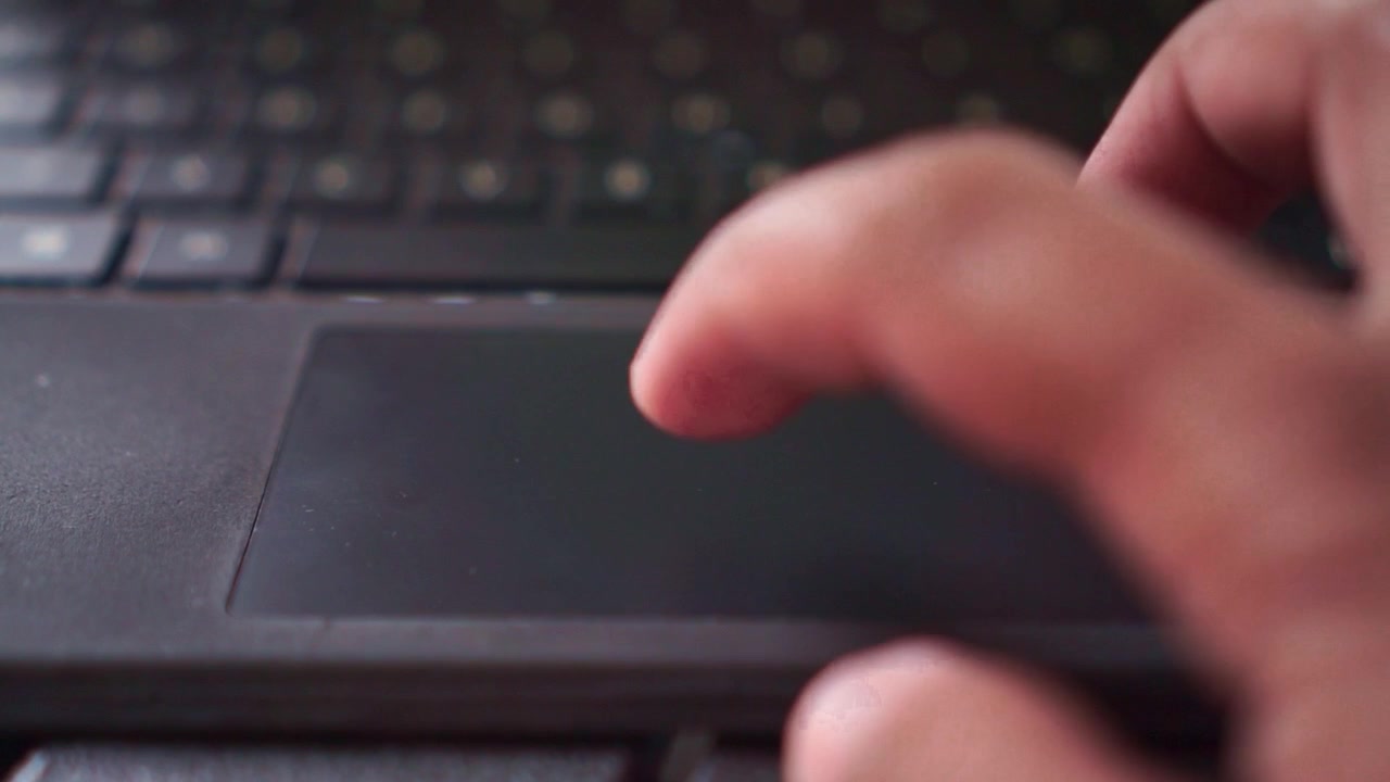 Human finger using laptop touchpad to scroll, closeup shot, digital workflow, modern device, internet browsing.
