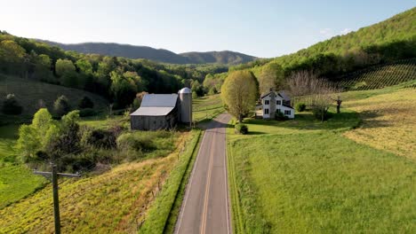 aerial-farmhouse-and-barn-down-roadway-near-bethel-nc,-north-carolina-near-boone-and-blowing-rock-north-carolina