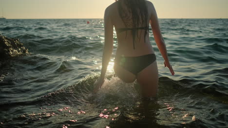 woman enjoying sunset by the sea