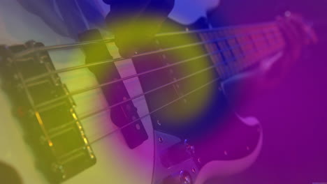male musician plucking bass guitar under stage lights, with animated equalizer bars overlaying