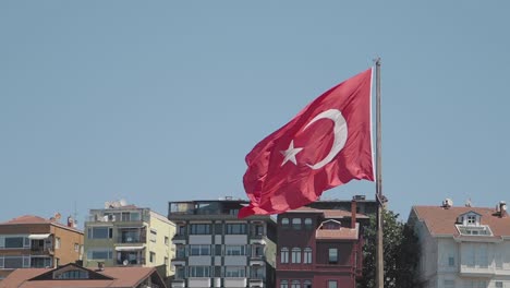 turkish flag waving above buildings in istanbul