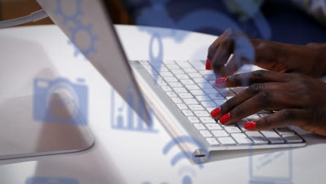 animation of technology icons over african american woman using laptop