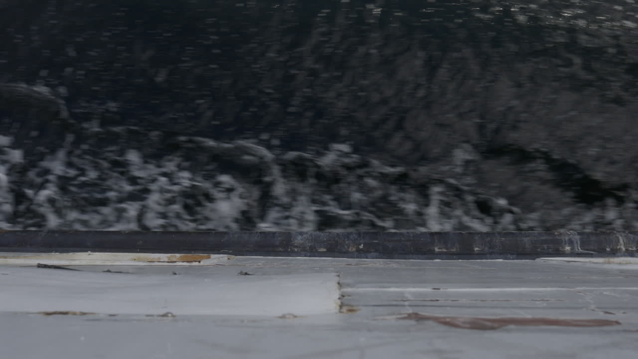 Top-down on a water waves and the side of the ferry