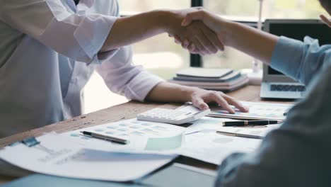 close up shot of unrecognizable multi-ethnic business people standing in front of each other making agreement and doing handshake.