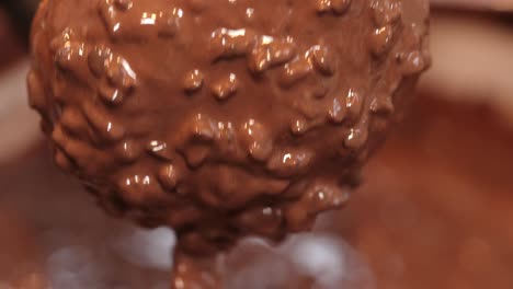 cholotae ferrero donut being decorated dipped in cholocate