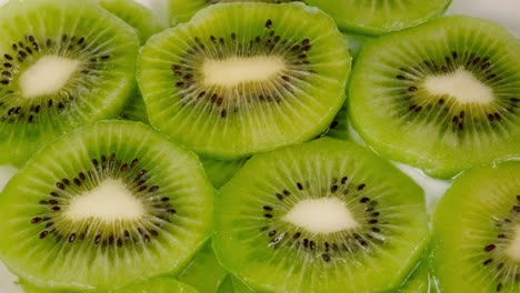 milk fills fresh kiwi slices. close up, top view. 4k, slow motion.