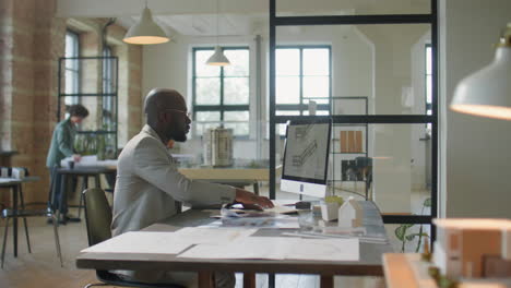 professional architect working on design plans in a modern office studio