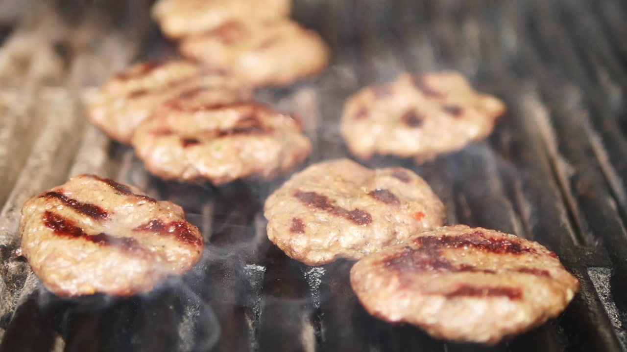 Close-up of Meat Patties Sizzling on a Hot Grill