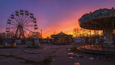 captivating sunset over abandoned amusement park featuring a ferris wheel and carousel in twilight's glow with eerie yet beautiful atmosphere