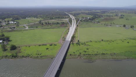 Aerial-Pullback-Over-Pacific-Highway-Revealing-Macleay-Valley-Bridge-Spanning-Macleay-River-In-New-South-Wales,-Australia