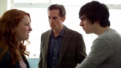 an intense emotional confrontation: a dramatic scene unfolds between two young individuals and a mediating adult, reflecting tension and conflict in a classroom setting
