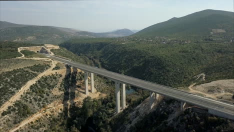 Aerial-footage-of-a-highway-bridge-in-Bosnia-and-Herzegovina-with-mountains-and-hills-in-the-distance