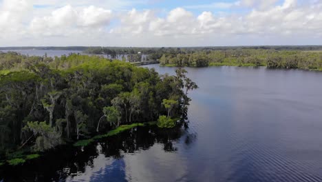 Aerial-of-a-beautiful-lake-with-some-reflection-of-the-clouds