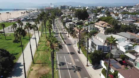 aerial descending view above los angeles beach suburb skyline down to waterfront neighbourhood street