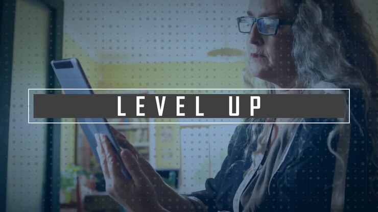Animation of level up text over caucasian woman using tablet