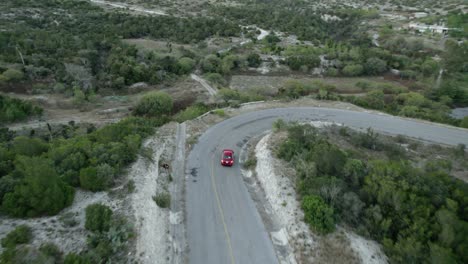 aerial - car driving down many curves in hill road, tamaulipas, mexico, tracking