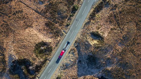 Top-down-view-of-truck-on-Scottish-Highland-road-with-slow-rotation-near-Loch-Loyne-Scotland