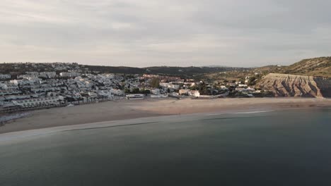 Wide-View-of-Praia-da-Luz-beach-at-dusk,-Algarve,-Portugal---Aerial