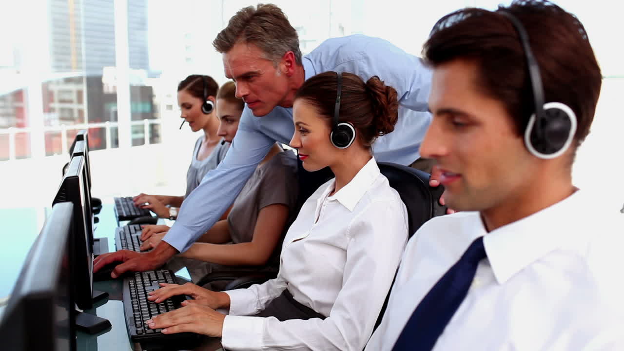 Smiling business people working in a call centre