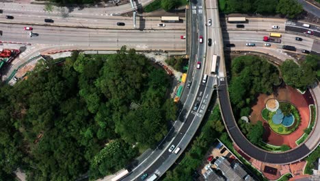 Drone-Aerial-Top-View-of-Flyover-inside-intersection-commercial-and-residential-downtown,-Mong-Kok-Kowloon-of-Hong-Kong-City-Skyline