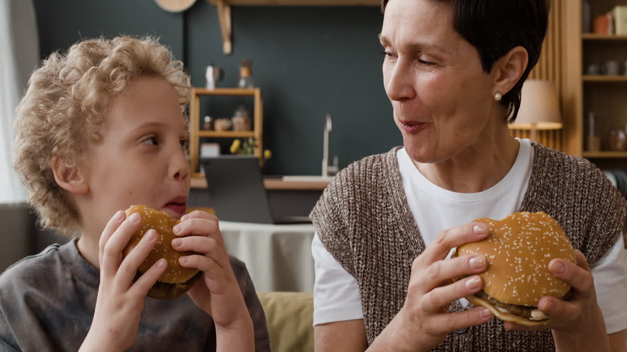Grandmother and Grandson Enjoying Burgers Together