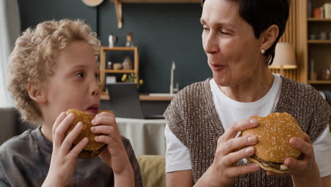 grandmother and grandson enjoying burgers together