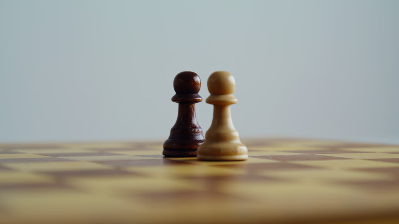 Wooden pawns standing chessboard closeup. Brown white chess pieces game figures