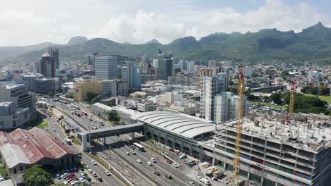 Aerial-panoramic-shot-of-Victoria-urban-terminal-with-bus-station-and-skyscraper-buildings-of-Port-Louis-Mauritius