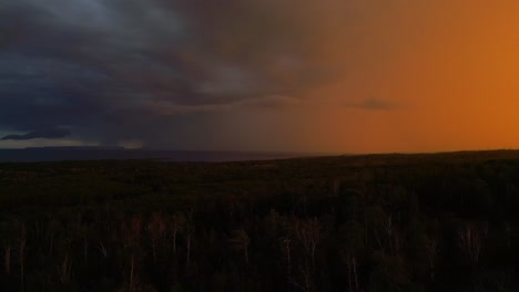 dramatic sunset and stormy sky over forest landscape
