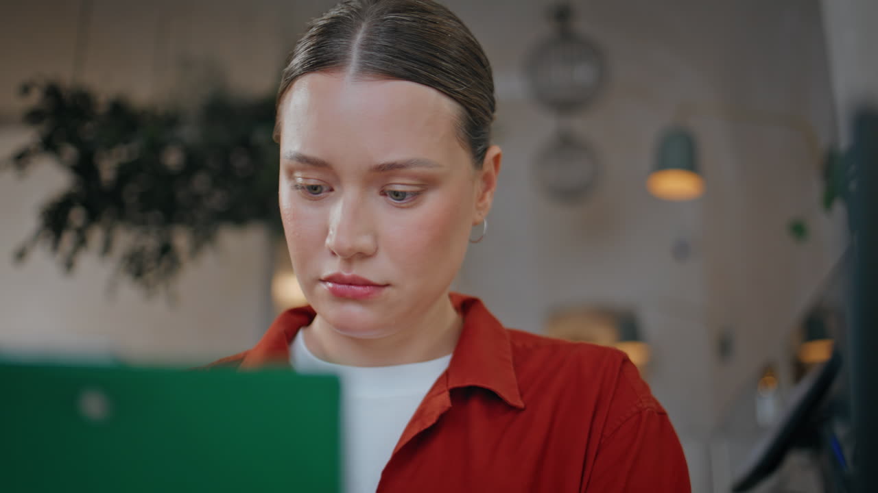 Cafeteria owner analyzing documents in modern interior closeup. Serious woman