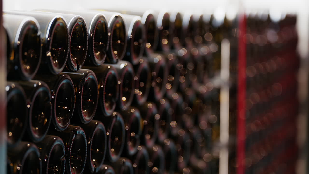Multiple wine bottles on racks at the Chateau de Cremat winery