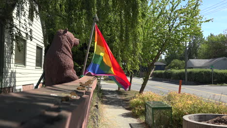 lgbtq flag blowing in the wind at sunny street.
